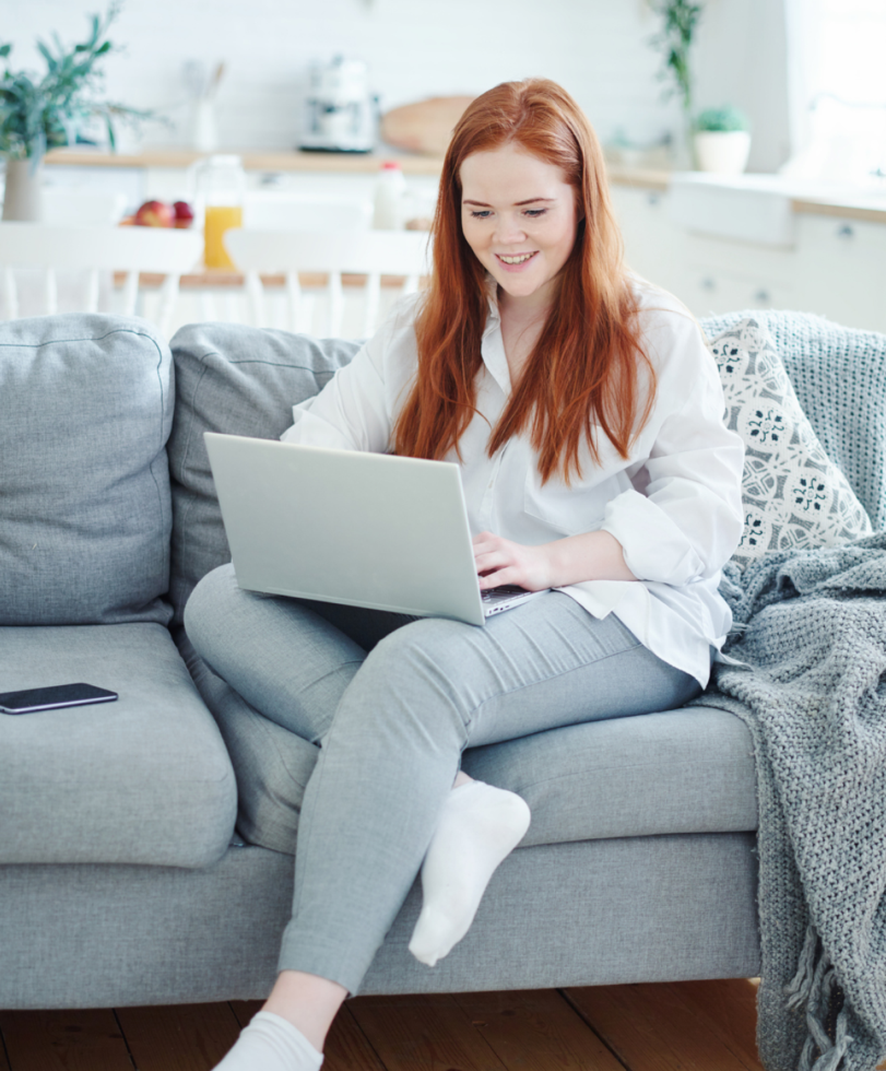 Woman with a laptop on a couch